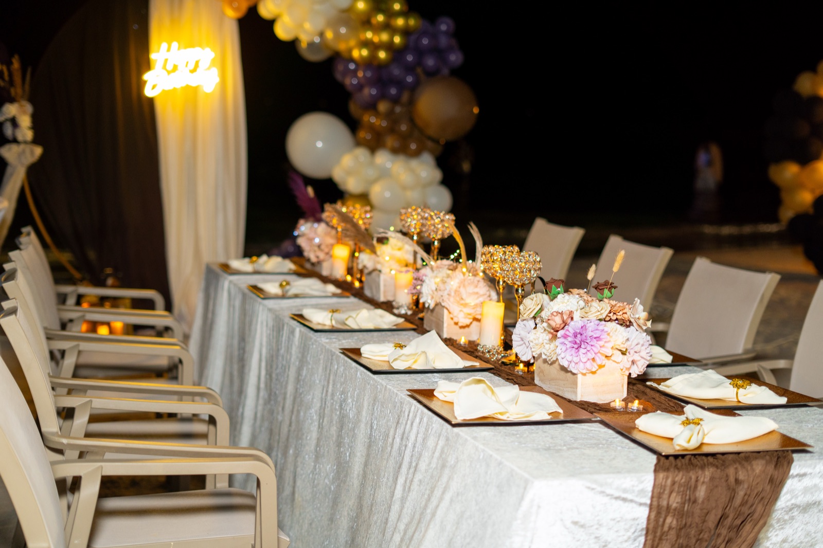 Place settings and florals along a long table